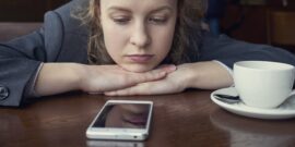 Disappointed,Sad,Woman,Looking,At,Phone,And,Waiting,Message,Or