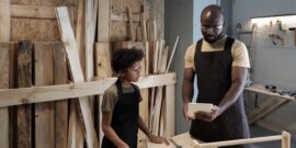 Portrait,Of,African-american,Father,Teaching,Son,Carpentry,While,Working,Together