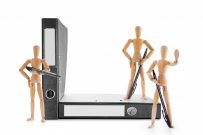 Three armed with pens wooden mannequins guarding office folders. Information security, legal protection or bureaucratic barriers concept