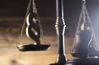 Law and justice concept. Scales of justice, gavel, paragraphs, brown wooden background, place for text