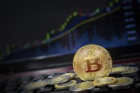 Bitcoin and world currency on keyboard with rising chart in background.