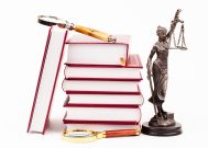 law book, money , magnifying glass and lady of justice