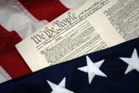 We The People – U.S. Constitution document and flag