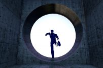 man running trough round window opening