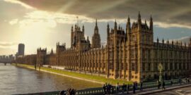 London England, the British parliament and Thames river under dramatic sky