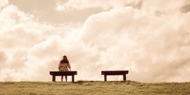 a women sitting alone on a bench waiting for love, alone concept
