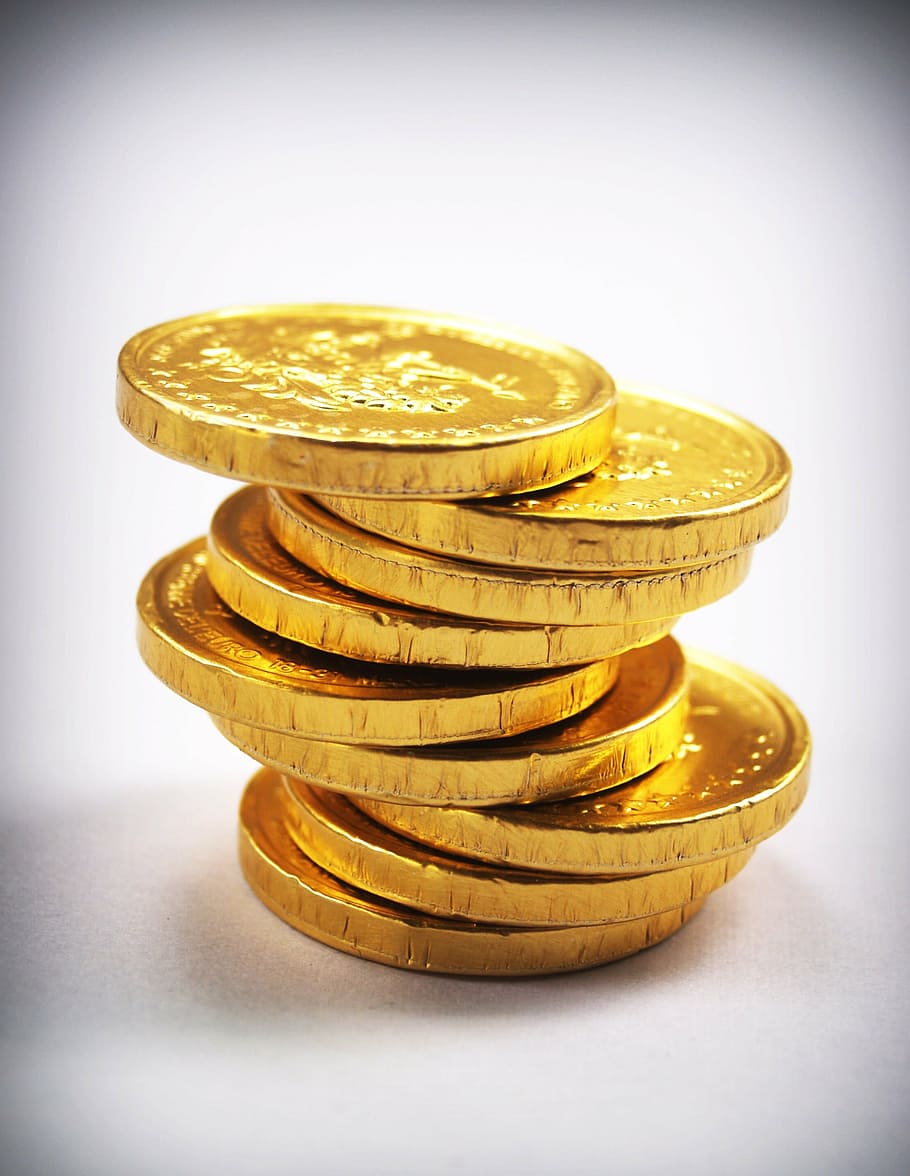 Gold coins being rolled over from a 401(k) account into a Gold IRA account.